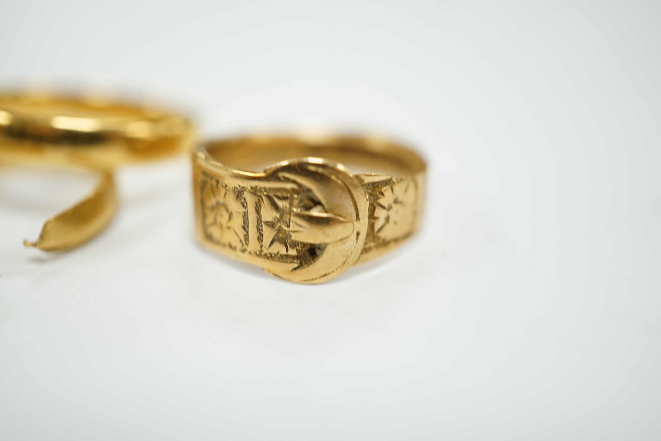 Two 22ct gold wedding bands (one cut), 5.8 grams and an 18ct gold buckle ring, 2.9 grams.
